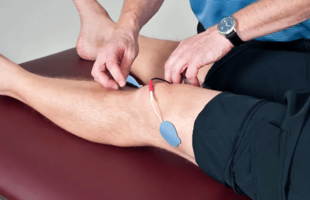 pic of therapist placing electrodes on a persons leg